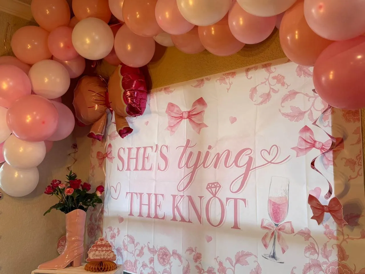 Pink balloon garland around a bridal shower backdrop styled by Oak & Lace