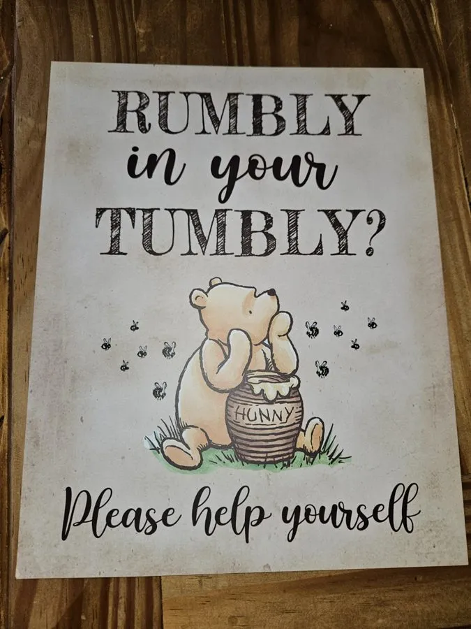 Rumbly in Your Tumbly sign with Pooh and a honey pot