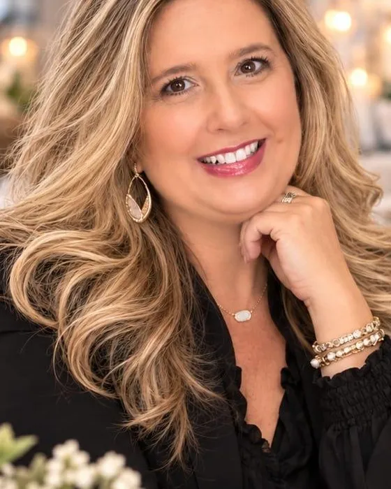 Tammy, the event planner behind Oak & Lace, smiling with her hand resting under her chin